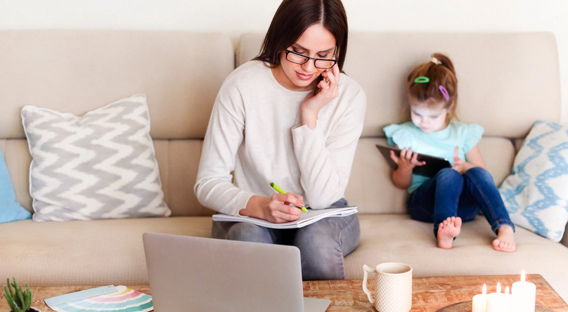 A woman working remotely without worrying about leaving her kid to daycare