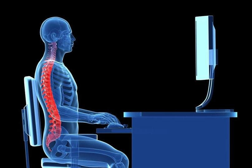 A skeleton maintaining ergonomics, typing on computer keyboard