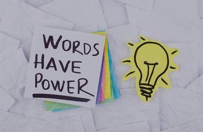 A piece of paper on which a sentence is typed that says - "Words Have Power."