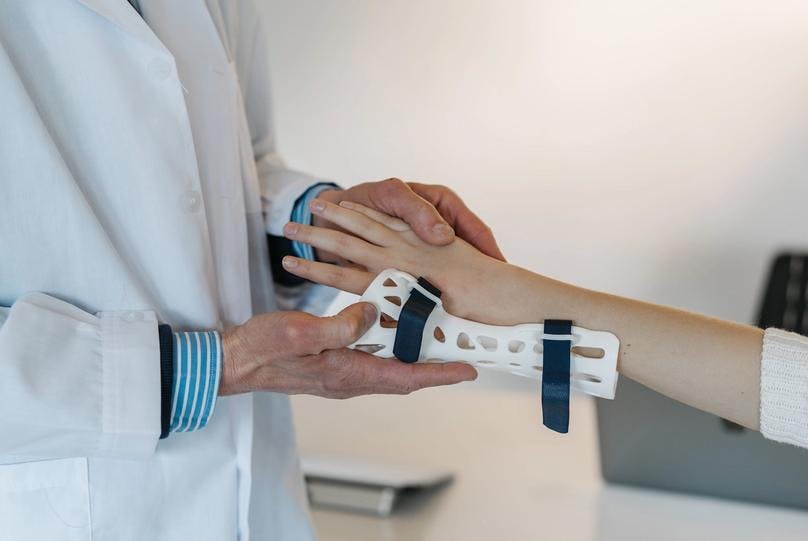A doctor is fixing a wrist as a prevention of typing injuries