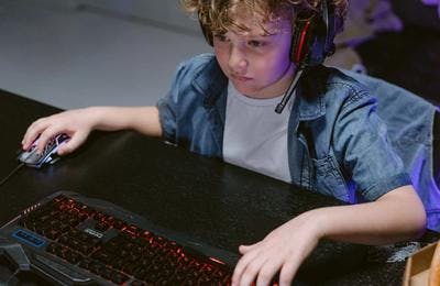 A kid playing games on his computer