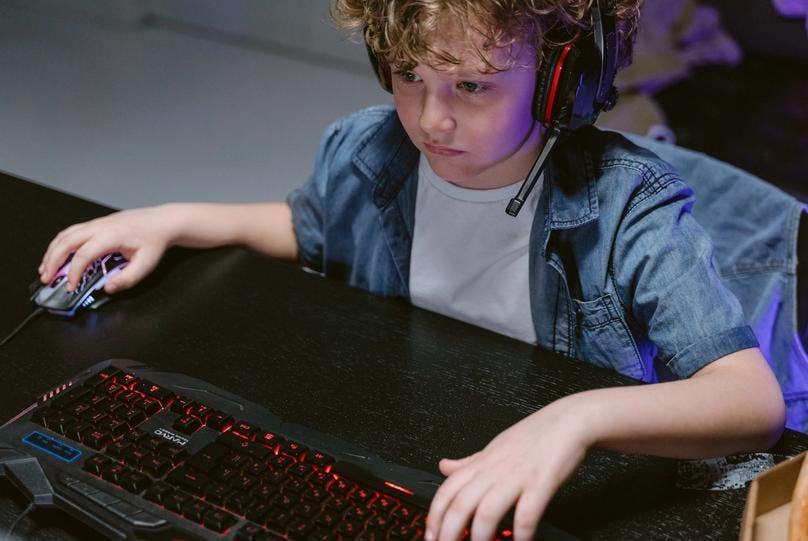 Kid playing some selected typing games for kids