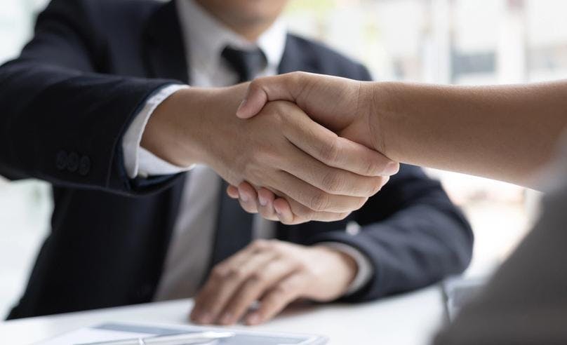 An employer shaking hand with the candidate to are selected for the job through typing test process