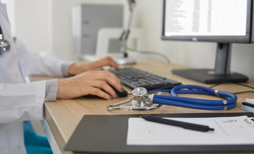 A healthcare professional typing