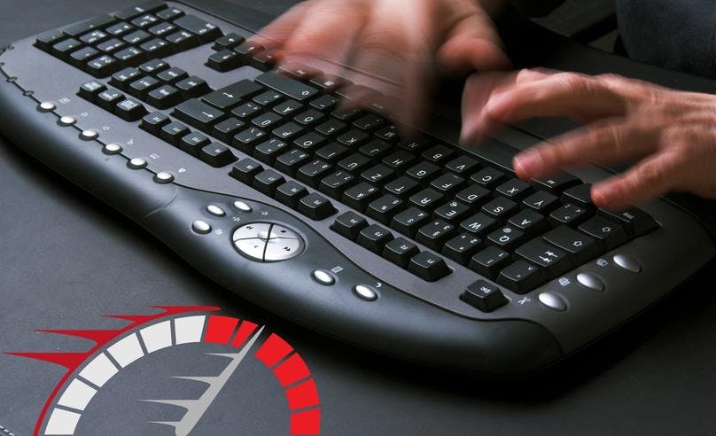 two hands typing very fast on a desktop keyboard and measuring typinbg speed