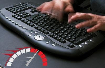 two hands typing very fast on a desktop keyboard